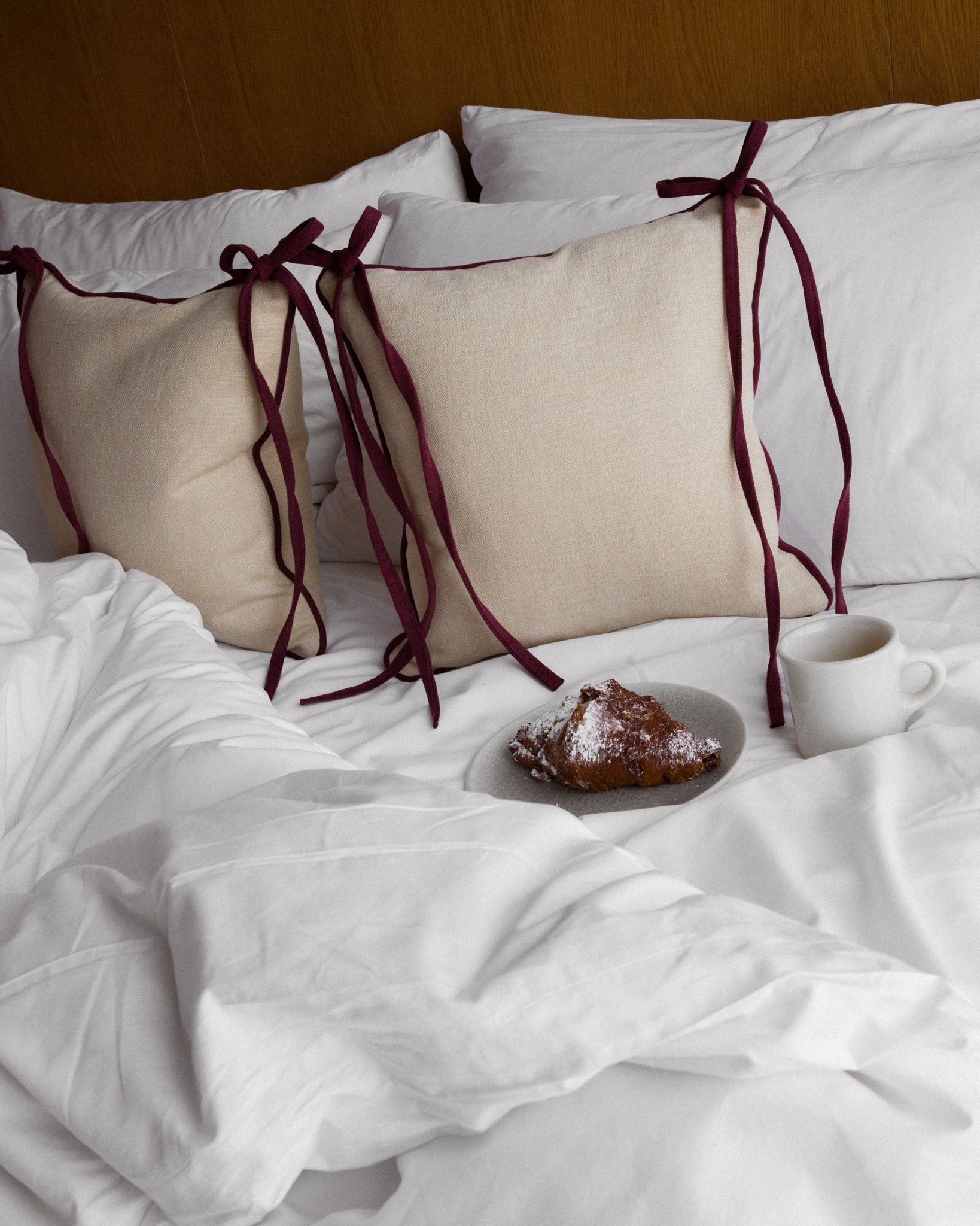 Trace linen cushion in Butterbean and Radicchio with bowed ties, Soft Service by Studio Nicholas, Noosa