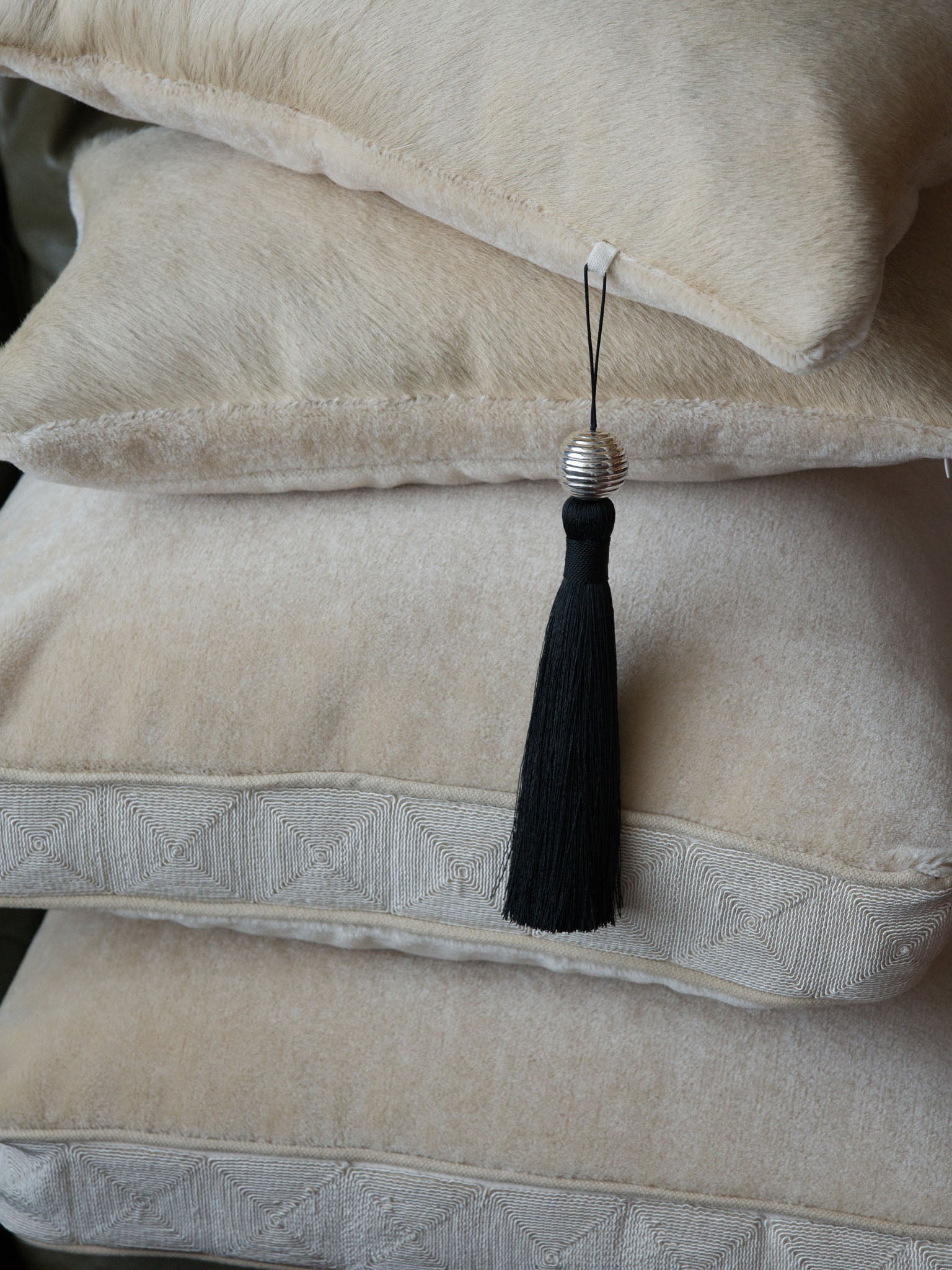 Lilt hair-on hide cushion with Sway tassel beside Chime mohair cushion, Soft Service by Studio Nicholas, Noosa