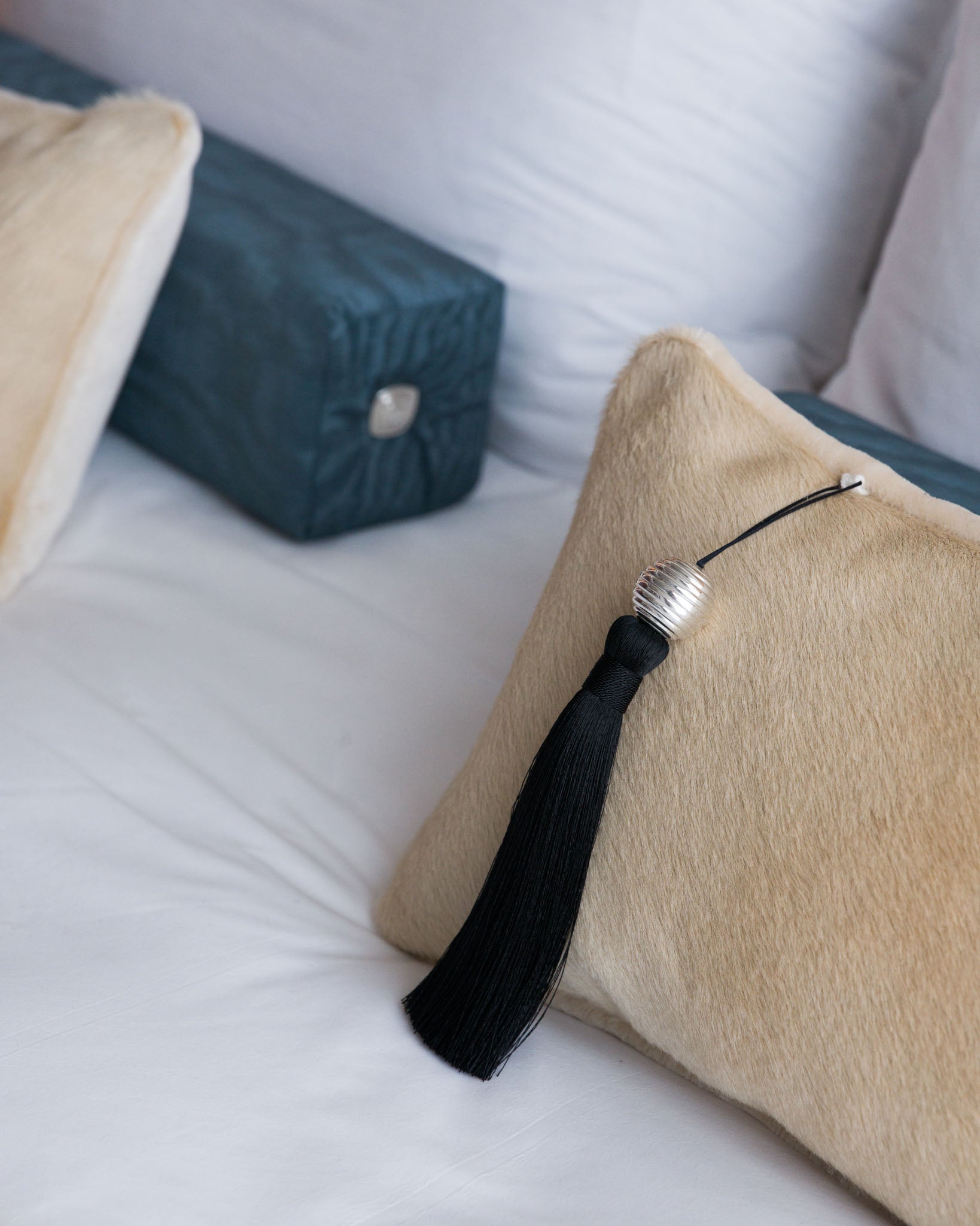 Lilt hair-on hide cushion with Sway tassel and Lull moiré bolster, Soft Service by Studio Nicholas, Noosa